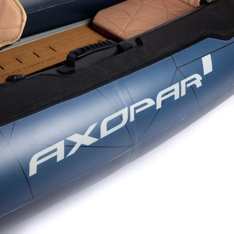 Close-up of a blue AXOPAR inflatable boat with brown interior on a white background